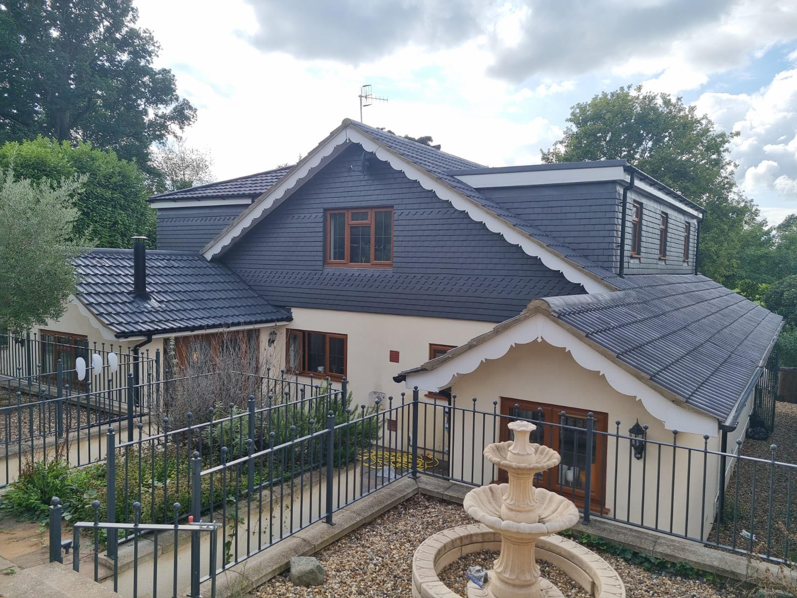 A house with fresh roof coating done by The Roof Cleaning Experts