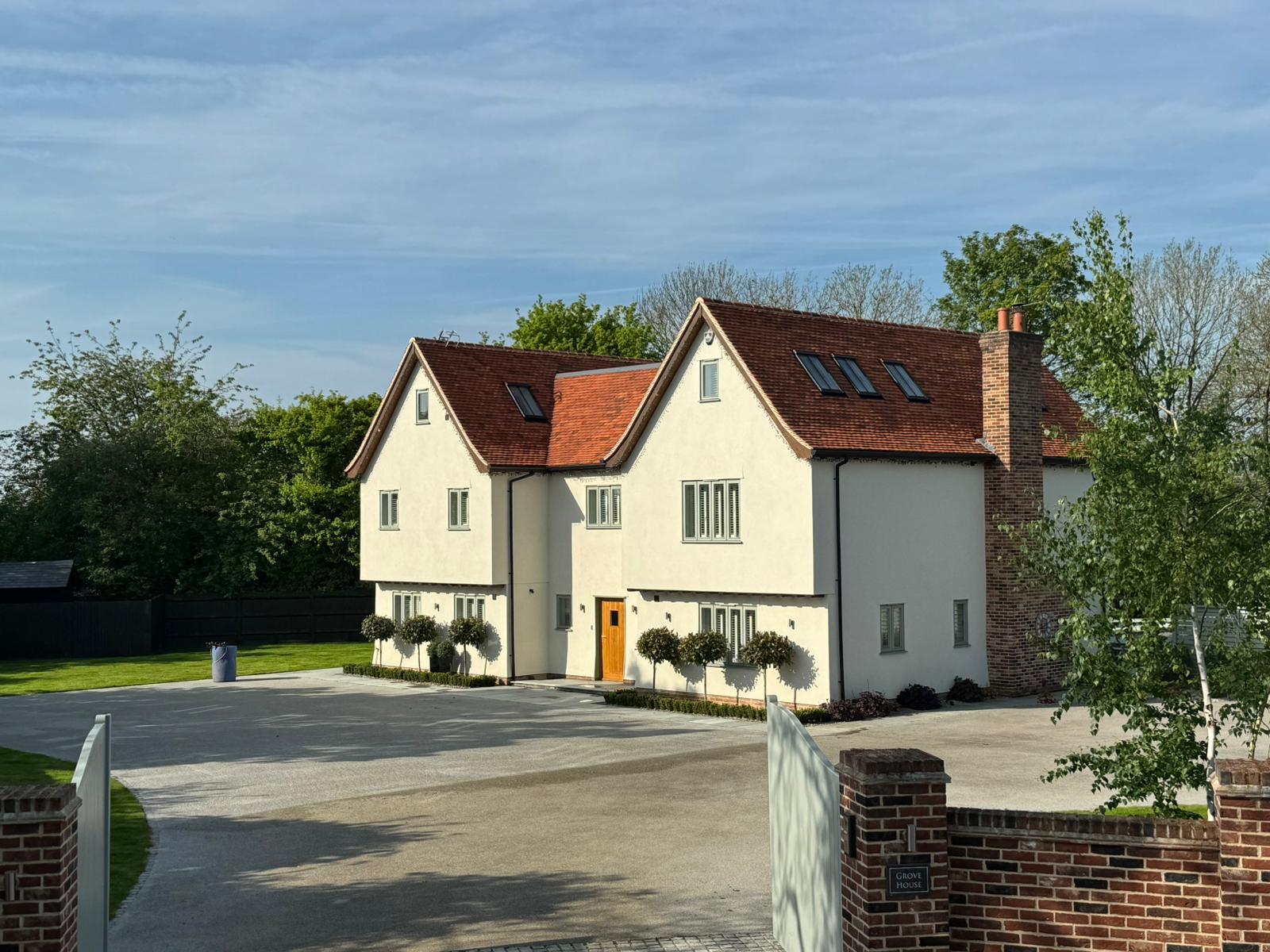 Large modern home with a freshly cleaned and coated rendered exterior and a spotless driveway.