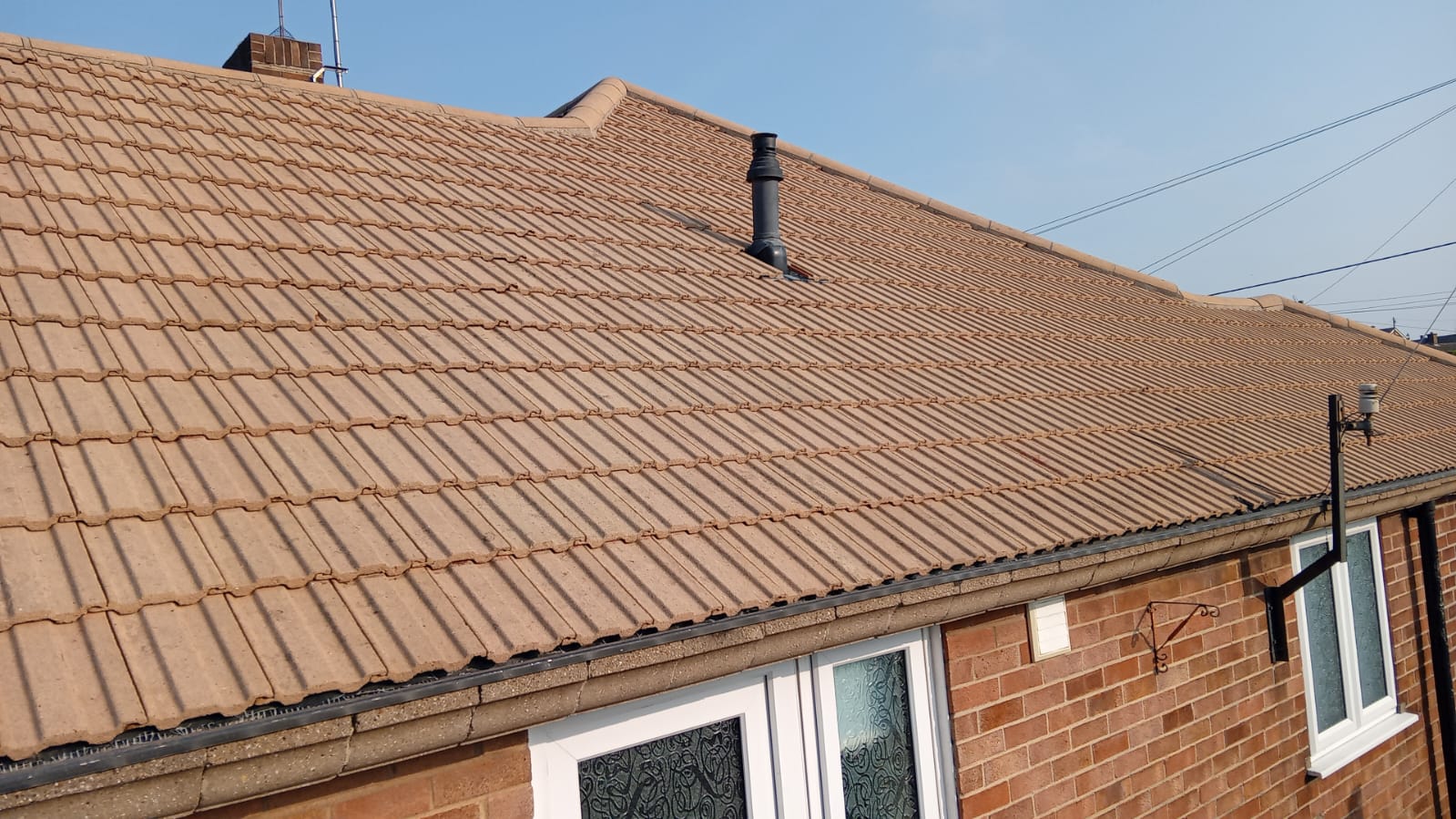 House after roof cleaning and moss removal in Essex