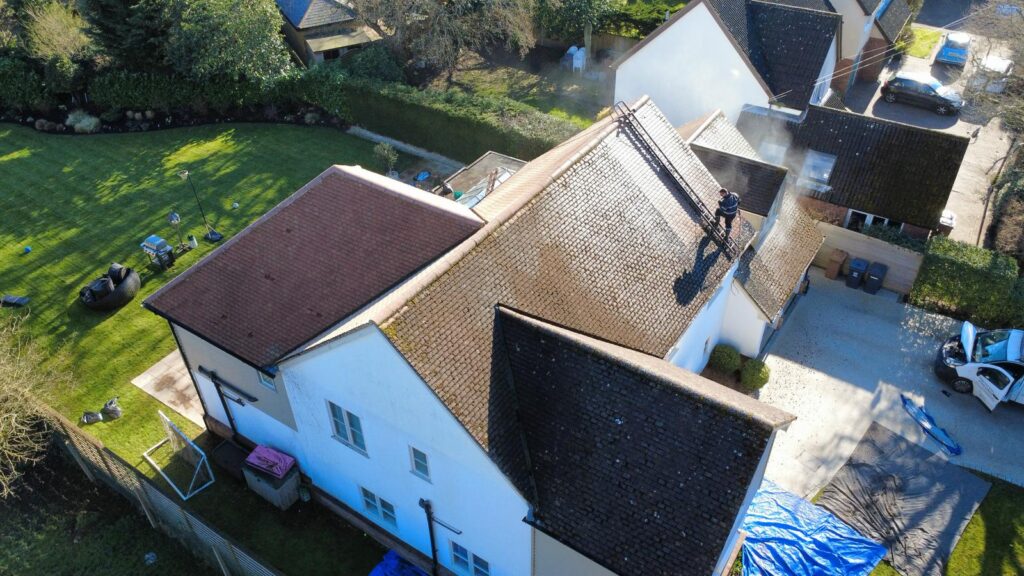 Roof cleaning and moss removal in progress by The Roof Cleaning Experts.