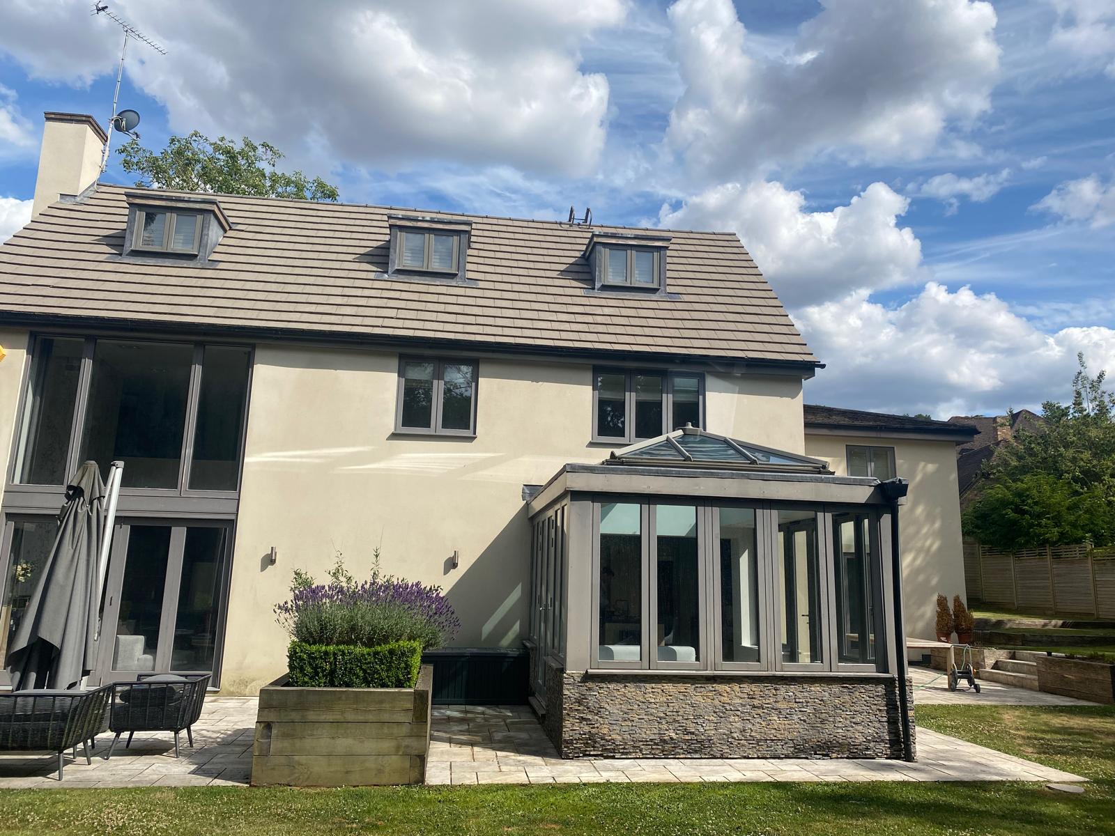 Professional roof cleaning in the UK removing moss, algae, and dirt buildup to protect roof tiles and improve home appearance.