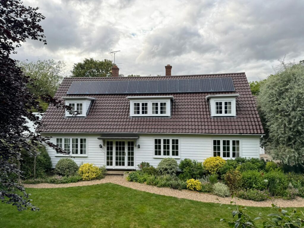 Clean roof with protective coating applied, showing smooth, water-repellent tiles on a modern home.