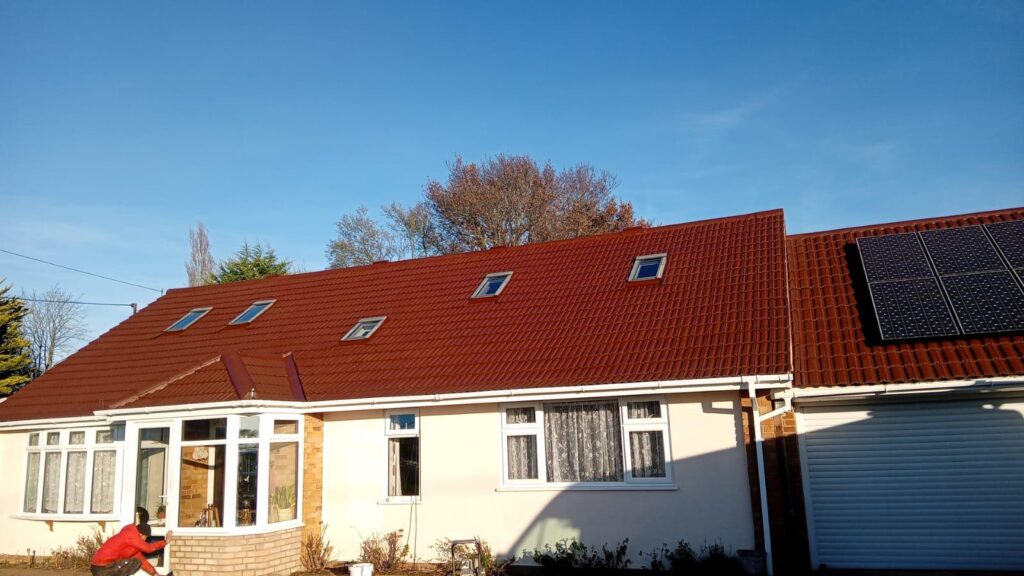Freshly cleaned and coated red concrete roof tiles after professional roof tile cleaning and Properla coating